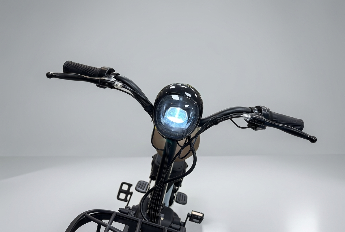 Close-up of a motorcycle handlebar with headlight on a gray background
