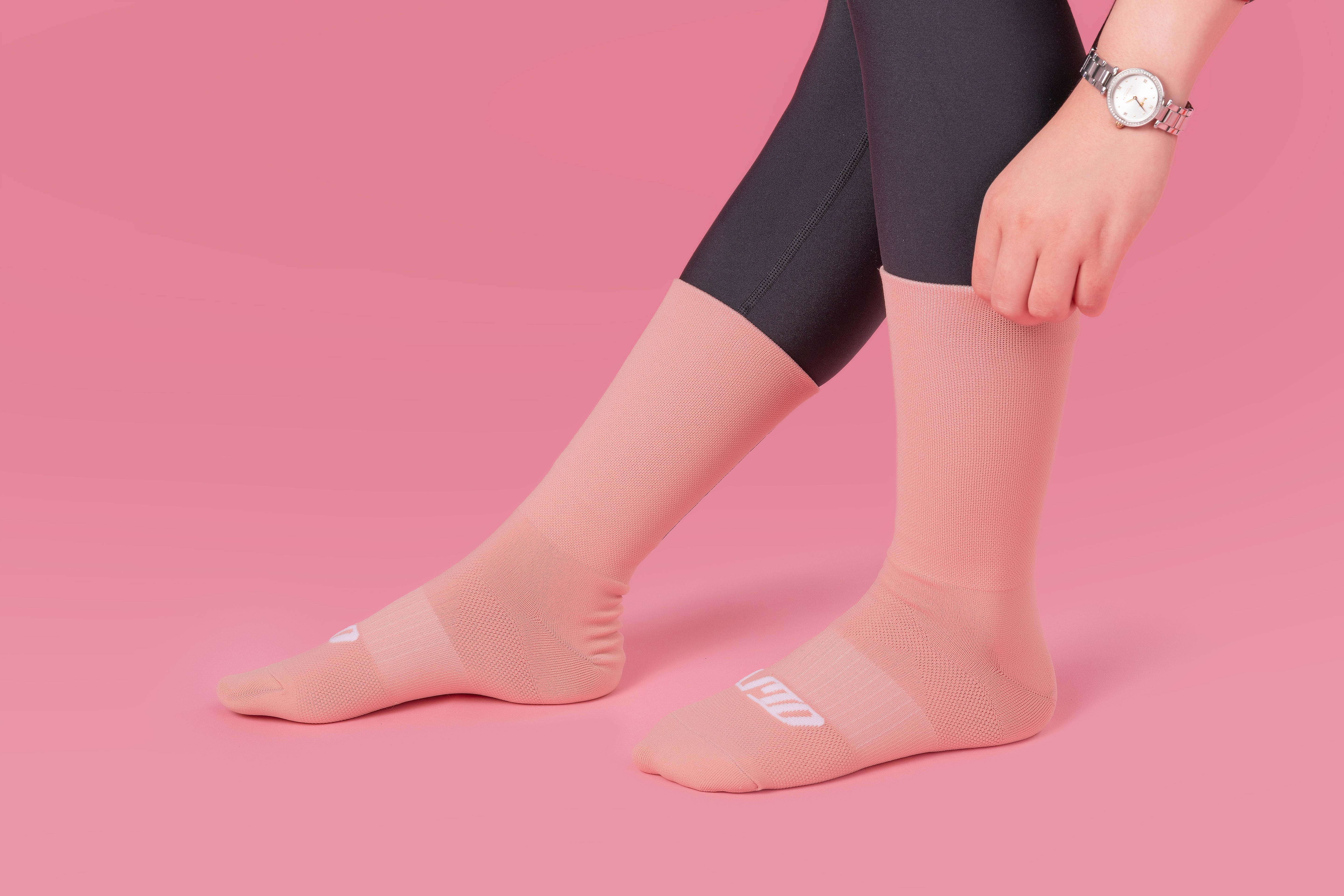 Girl putting pink reflective socks with pink backgorund
