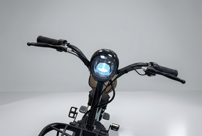 Close-up of a motorcycle handlebar with headlight on a gray background
