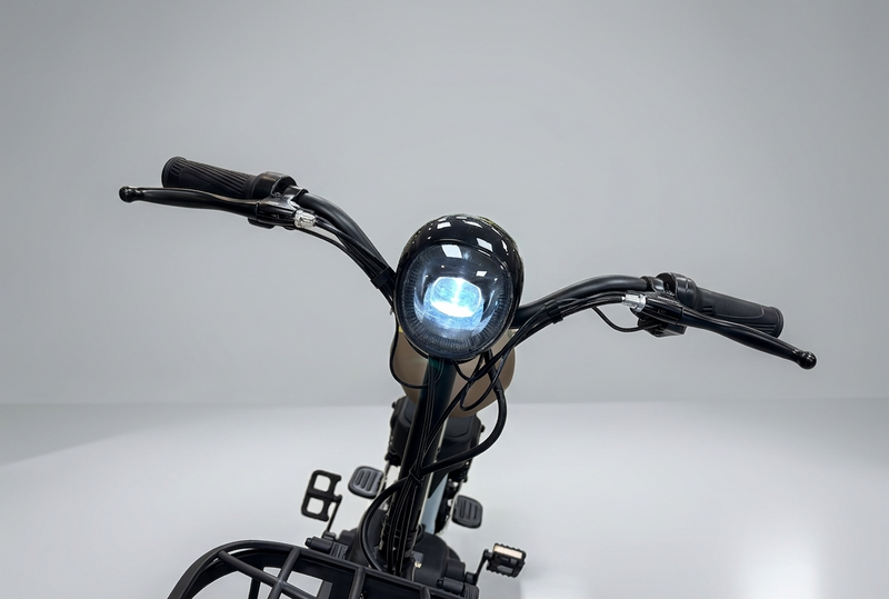 Close-up of a motorcycle handlebar with headlight on a gray background